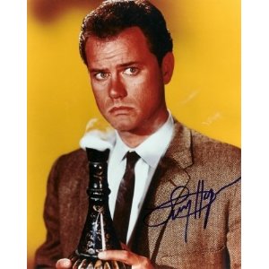 Man holding a smoky bottle, looking concerned.